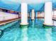 Bright indoor pool area with decorative pillars and blue accents at 2007 S Ocean Blvd. # 401, Myrtle Beach, SC 29577