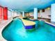Indoor lazy river style pool with blue tile and yellow accents at 2007 S Ocean Blvd. # 401, Myrtle Beach, SC 29577