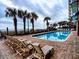 Outdoor pool with lounge chairs and palm tree accents at 2007 S Ocean Blvd. # 401, Myrtle Beach, SC 29577