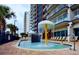 Resort's Gathering-friendly splash pad with water features and plenty of lounge chairs at 2007 S Ocean Blvd. # 401, Myrtle Beach, SC 29577