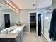 Bathroom featuring a large mirror, a walk-in shower, and a grey vanity with light countertops at 276 Palmetto Glen Dr., Myrtle Beach, SC 29588