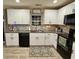 Bright kitchen with white cabinets, black appliances, granite countertops, and stainless steel sink at 276 Palmetto Glen Dr., Myrtle Beach, SC 29588