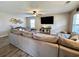 Spacious living room with a large sectional sofa, TV, modern decor, and hardwood floors at 276 Palmetto Glen Dr., Myrtle Beach, SC 29588