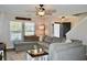 Cozy living room with a large sectional sofa, ceiling fan, and plenty of natural light at 276 Palmetto Glen Dr., Myrtle Beach, SC 29588