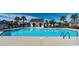 Community pool featuring sparkling water and a building with restrooms, surrounded by a fenced in area at 276 Palmetto Glen Dr., Myrtle Beach, SC 29588