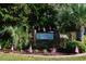 Entrance sign for Palmetto Glen, surrounded by lush landscaping and flags at 276 Palmetto Glen Dr., Myrtle Beach, SC 29588