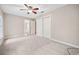 A bright bedroom with neutral carpet, a ceiling fan, closet and bathroom access at 3034 Oak Grove Bend # 34 Ar, Murrells Inlet, SC 29576
