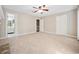 A bright bedroom with neutral carpet, a ceiling fan and doors to a bathroom and hallway at 3034 Oak Grove Bend # 34 Ar, Murrells Inlet, SC 29576