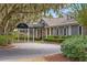 Elegant building exterior with covered entrance, showcasing its welcoming facade and mature landscaping at 3034 Oak Grove Bend # 34 Ar, Murrells Inlet, SC 29576