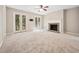 A spacious living room featuring a fireplace, ceiling fan, and glass doors to the outside at 3034 Oak Grove Bend # 34 Ar, Murrells Inlet, SC 29576