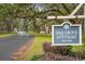 Oak Grove Cottages sign on a tree-lined road, showcasing the tranquil community setting at 3034 Oak Grove Bend # 34 Ar, Murrells Inlet, SC 29576