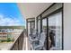 Relax on the spacious balcony with ocean view and comfortable seating, accessible through sliding glass doors at 5308 N Ocean Blvd. # 1014, Myrtle Beach, SC 29577