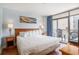 Bright bedroom boasts a balcony with ocean views and hardwood floors at 5308 N Ocean Blvd. # 1014, Myrtle Beach, SC 29577