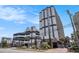 The exterior of a condo complex featuring neutral toned exteriors with an attached parking deck at 5308 N Ocean Blvd. # 1014, Myrtle Beach, SC 29577
