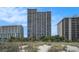 Oceanfront condo building with balconies and lush vegetation, offering stunning views from every floor at 5308 N Ocean Blvd. # 1014, Myrtle Beach, SC 29577