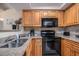 Cozy kitchen features granite countertops, stainless steel sink, and black appliances at 5308 N Ocean Blvd. # 1014, Myrtle Beach, SC 29577