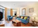 Comfortable living room seating with a blue couch, wood accents, and views of the building next door at 5308 N Ocean Blvd. # 1014, Myrtle Beach, SC 29577