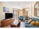 The living room is furnished with comfortable blue seating, a wood coffee table and a TV at 5308 N Ocean Blvd. # 1014, Myrtle Beach, SC 29577
