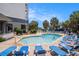 Enjoy the swimming pool area with blue lounge chairs, palm trees, and seating areas at 5308 N Ocean Blvd. # 1014, Myrtle Beach, SC 29577