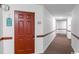 Interior hallway with a red door and light-colored walls at 1100 Possum Trot Rd. # F-215, North Myrtle Beach, SC 29582