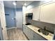 White kitchen with granite countertops and stainless steel sink at 1100 Possum Trot Rd. # F-215, North Myrtle Beach, SC 29582