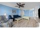 Open living room and bedroom area with a sofa and TV at 1100 Possum Trot Rd. # F-215, North Myrtle Beach, SC 29582