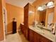 A bathroom featuring a single sink, granite countertops, wooden cabinets, and neutral colored walls at 2347 Devine St., Georgetown, SC 29440