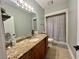 Well-lit bathroom featuring granite counters, tile floors and a shower with a patterned curtain at 2347 Devine St., Georgetown, SC 29440