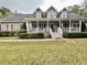 Inviting home with a classic front porch, complemented by well-kept landscaping and dormer windows at 2347 Devine St., Georgetown, SC 29440