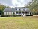 Beautiful two-story home boasting a spacious front porch, dormer windows, and a lush green lawn at 2347 Devine St., Georgetown, SC 29440