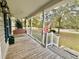 Cozy front porch featuring a wooden swing, white railing, and a view of the neighborhood at 2347 Devine St., Georgetown, SC 29440