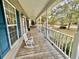 Inviting front porch with rocking chair, white railing, and a view of the neighborhood at 2347 Devine St., Georgetown, SC 29440