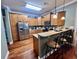 A cozy kitchen with wood cabinets, stainless steel appliances, and a breakfast bar with stools at 2347 Devine St., Georgetown, SC 29440