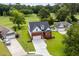 Aerial view of a red brick home on a lush lot backing onto a golf course at 428 Meadow View Ct., Longs, SC 29568