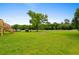 Large backyard perfect for outdoor activities with beautiful views of the golf course in the distance at 428 Meadow View Ct., Longs, SC 29568