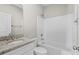 Well-lit bathroom featuring a white vanity with a granite countertop and a shower-tub combo with white enclosure at 428 Meadow View Ct., Longs, SC 29568