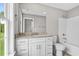 Bright bathroom with a granite countertop vanity, white cabinets and a tub-shower combo at 428 Meadow View Ct., Longs, SC 29568
