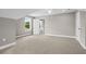 Carpeted bonus room with a view of a yard, neutral paint, and white trim at 428 Meadow View Ct., Longs, SC 29568