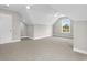 Bright, carpeted bonus room with neutral paint, a window with backyard view, and two ceiling fans at 428 Meadow View Ct., Longs, SC 29568