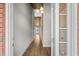 Long hallway featuring hardwood floors, gray walls, and a wooden ceiling at 428 Meadow View Ct., Longs, SC 29568