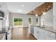 Bright, modern kitchen features granite countertops, stainless steel appliances, and wood ceiling accent at 428 Meadow View Ct., Longs, SC 29568