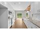 Modern kitchen with white cabinetry, granite countertops, and stainless steel appliances at 428 Meadow View Ct., Longs, SC 29568