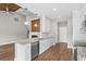 Open kitchen area with granite countertops, stainless steel appliances, and view into living area at 428 Meadow View Ct., Longs, SC 29568