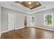 Bright primary bedroom featuring tray ceiling and ensuite bathroom with glass shower at 428 Meadow View Ct., Longs, SC 29568
