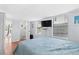 Cozy bedroom features wood floors, wainscoting, and a mounted TV for relaxed vacation living at 6001-S32 S Kings Hwy., Myrtle Beach, SC 29575