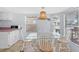 Light-filled dining area with a glass table, seating for four, and a decorative pendant light at 6001-S32 S Kings Hwy., Myrtle Beach, SC 29575