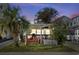 Charming single-story home featuring a large front porch, well-kept lawn, and a mature palm tree at 6001-S32 S Kings Hwy., Myrtle Beach, SC 29575