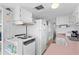 Compact kitchen featuring white appliances, ample cabinet space, and light pink countertops at 6001-S32 S Kings Hwy., Myrtle Beach, SC 29575
