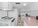 Efficient kitchen layout featuring white cabinets and appliances, plus pink countertops at 6001-S32 S Kings Hwy., Myrtle Beach, SC 29575