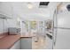 Efficient kitchen with white cabinetry, pink countertops, and a clear view to the dining area at 6001-S32 S Kings Hwy., Myrtle Beach, SC 29575